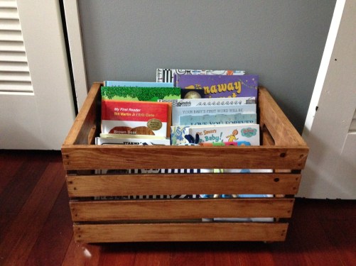 Here is one of our rolling apple crates for books. Brandon did such a great job sanding and staining them! We both did a good job on the wheels. 